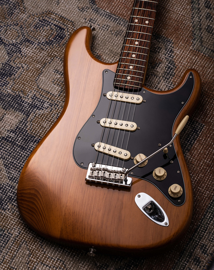 Fender American Professional II Stratocaster in brown colour which is lying on the carpet