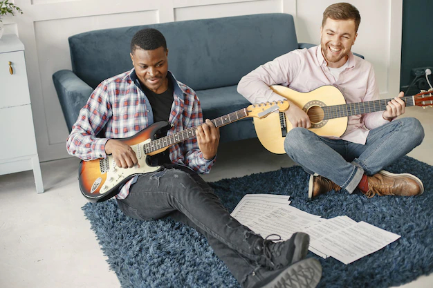 Two people playing guitars