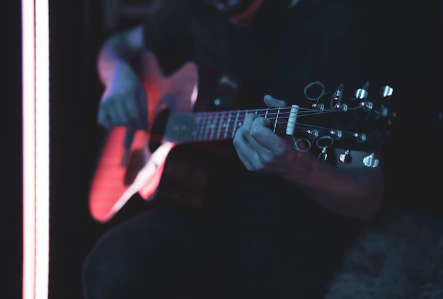 Man with a guitar in his hands performing a song