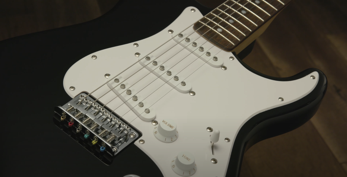 Close-up shot of a black and white colored electric guitar