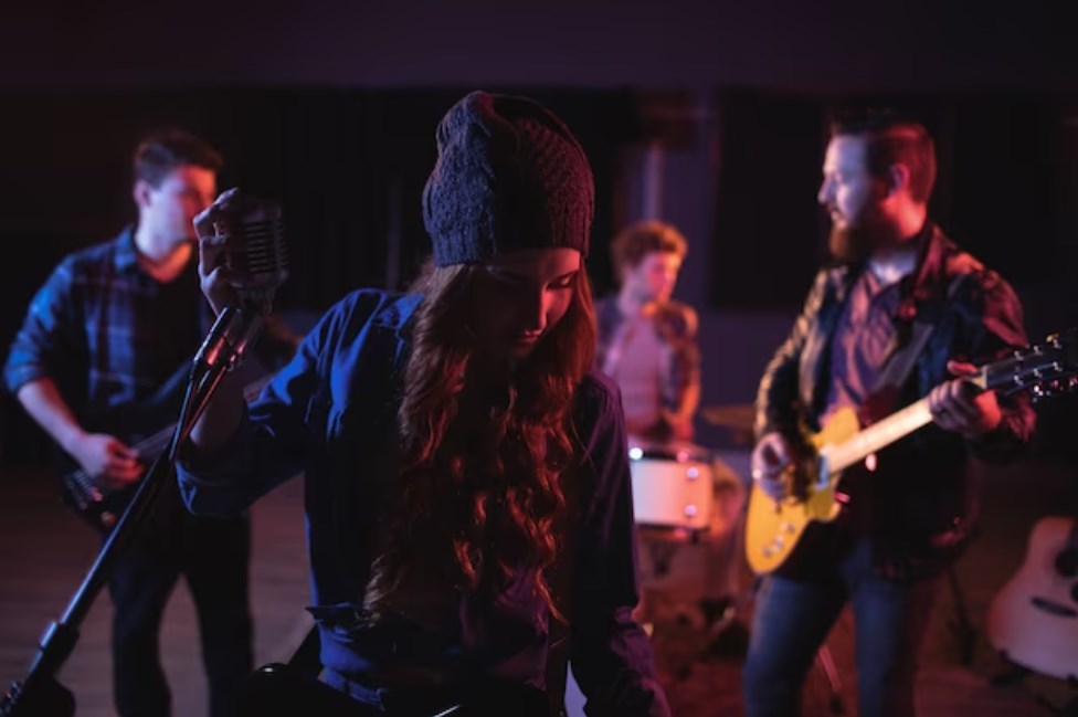 a photo of band mates performing together with a female lead singer