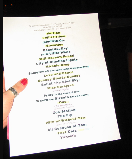 a woman's hand holds a sheet of paper with possible names of the musical group